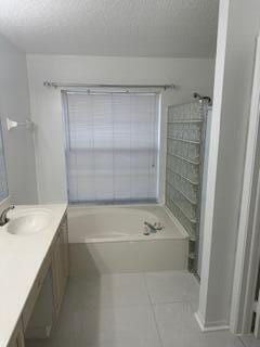 bathroom with tile patterned floors, a bathtub, and vanity