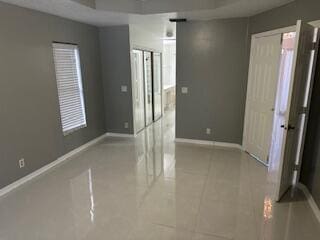 spare room featuring light tile patterned floors