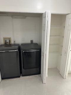 clothes washing area featuring washing machine and dryer