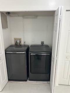 clothes washing area featuring separate washer and dryer