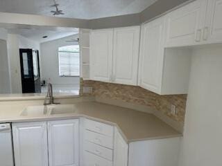 kitchen featuring white cabinetry, dishwasher, and sink