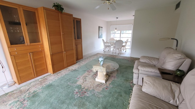 living room with ceiling fan and light tile patterned floors