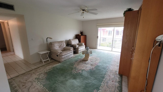 living room with light tile patterned floors and ceiling fan