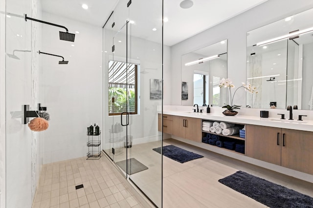 bathroom featuring tile patterned floors, a shower with door, and vanity