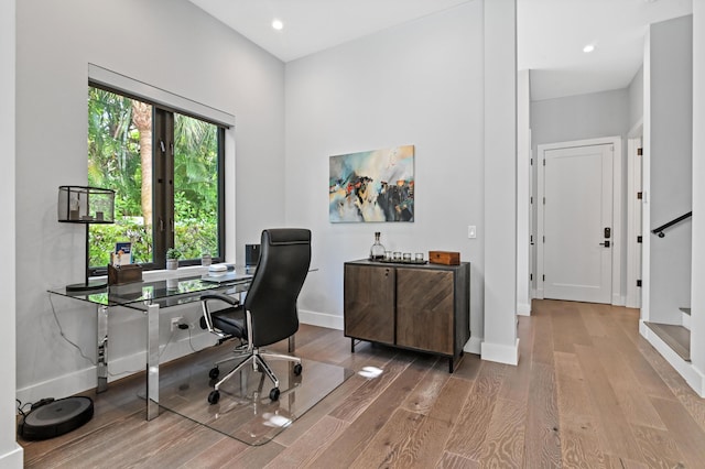 office area with baseboards, wood finished floors, and recessed lighting