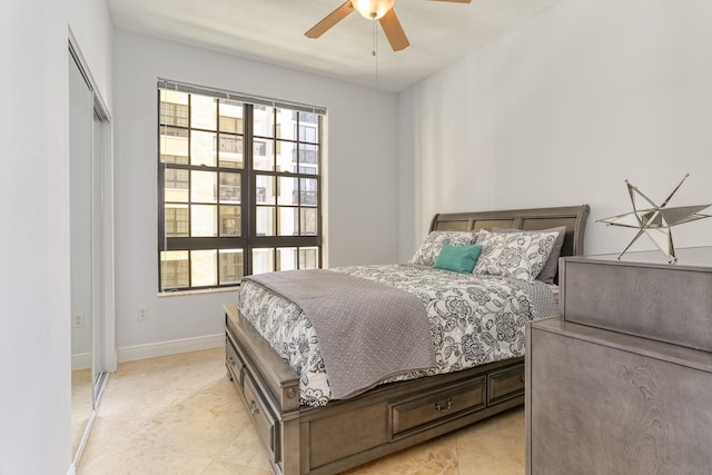 bedroom with ceiling fan, a closet, multiple windows, and light tile patterned floors