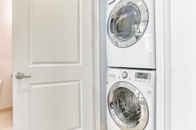 clothes washing area featuring stacked washer and dryer