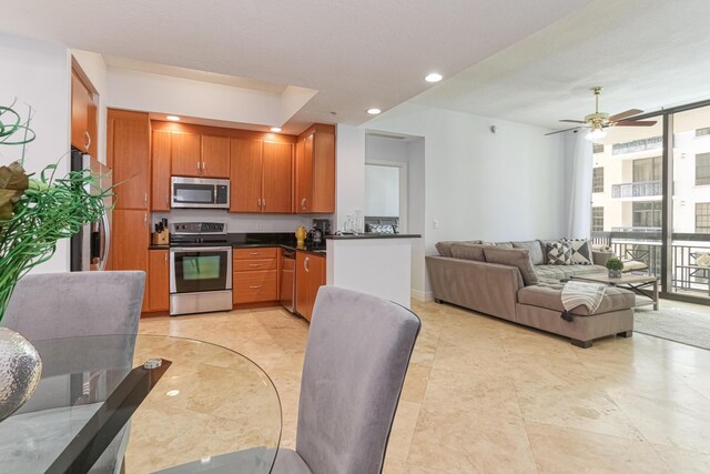 kitchen featuring ceiling fan, appliances with stainless steel finishes, and light tile patterned floors