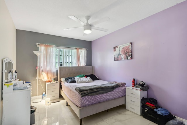 bedroom with ceiling fan and light tile patterned floors