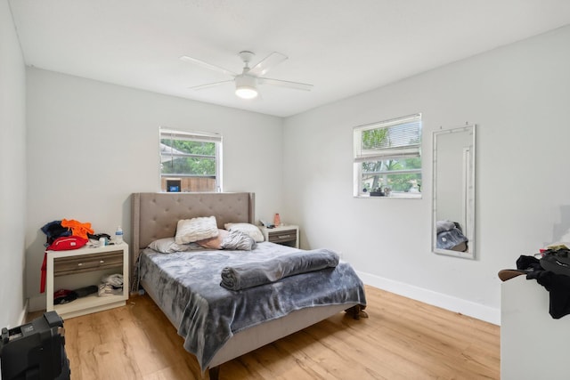 bedroom with ceiling fan and light wood-type flooring