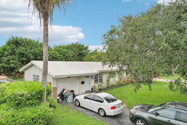 ranch-style home with a front yard and a garage