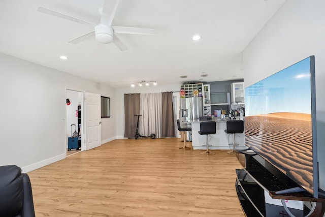 interior space featuring ceiling fan, light hardwood / wood-style flooring, and track lighting