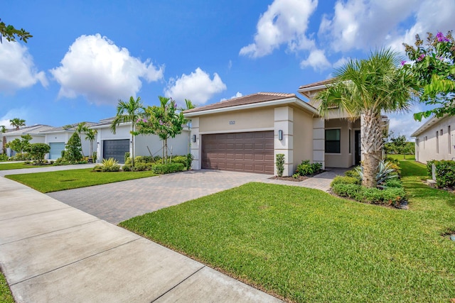 view of front of home with a garage and a front lawn