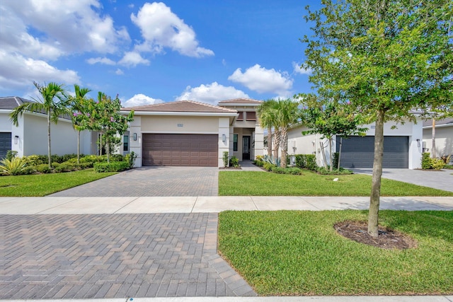 view of front of home with a garage and a front lawn