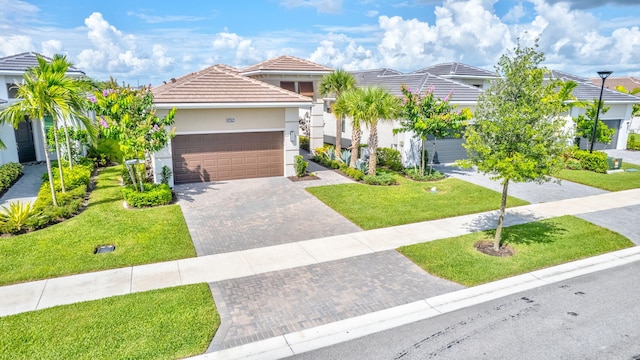 mediterranean / spanish house featuring a front lawn and a garage