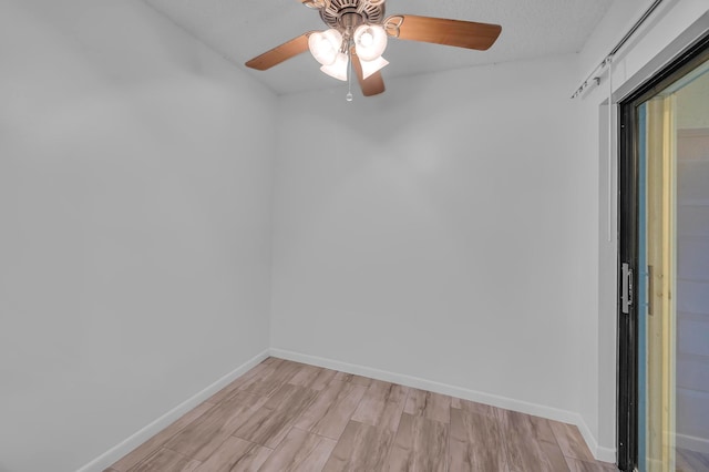 unfurnished room featuring ceiling fan and light hardwood / wood-style flooring