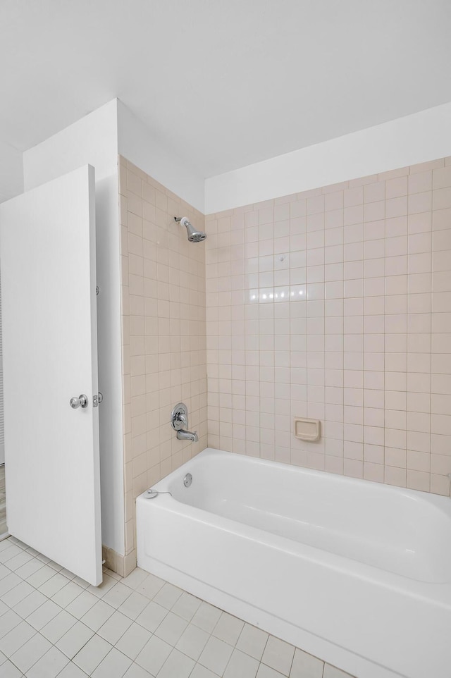 bathroom featuring tile patterned floors and tiled shower / bath