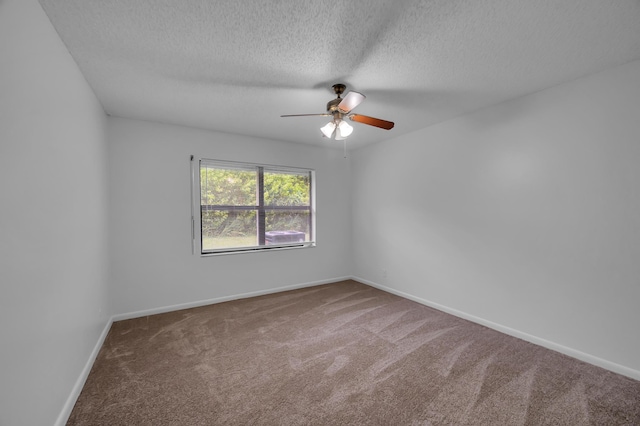 carpeted spare room featuring ceiling fan and a textured ceiling