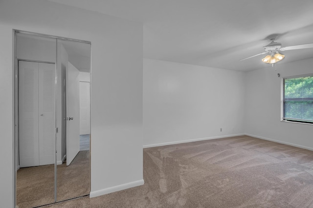 carpeted empty room with ceiling fan