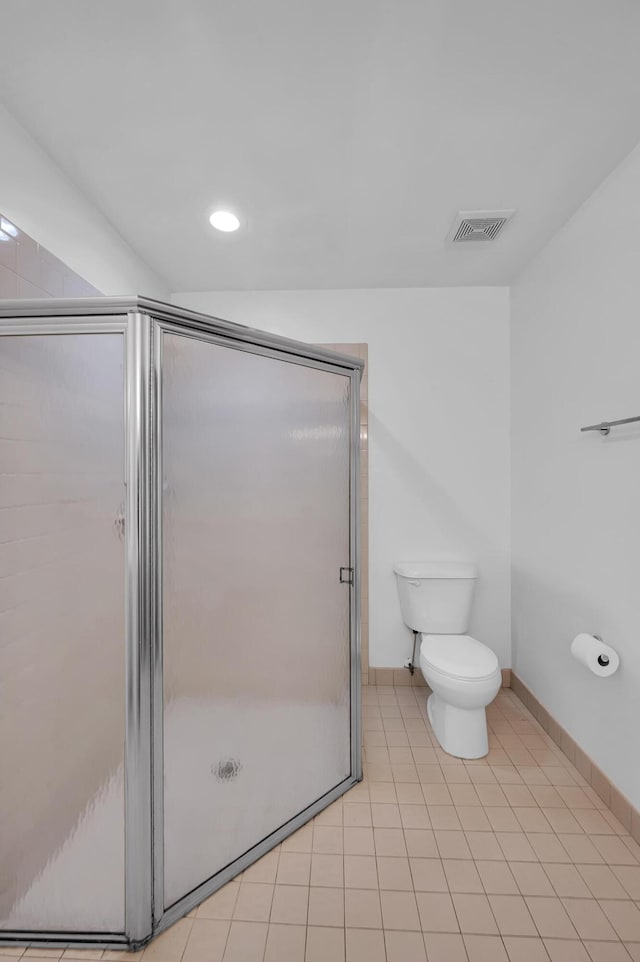 bathroom with walk in shower, toilet, and tile patterned flooring