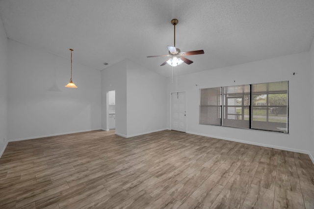 unfurnished living room featuring lofted ceiling, light wood-type flooring, and ceiling fan