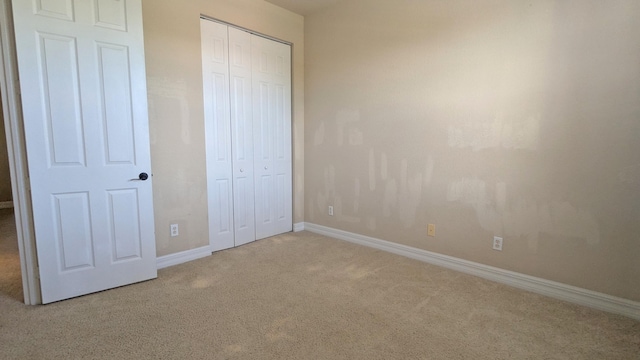 unfurnished bedroom featuring a closet and carpet