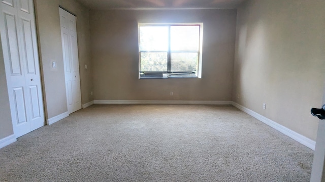 unfurnished bedroom featuring light colored carpet