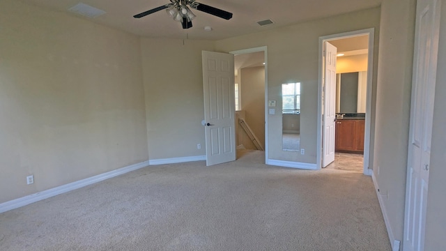 unfurnished bedroom featuring light carpet and ceiling fan