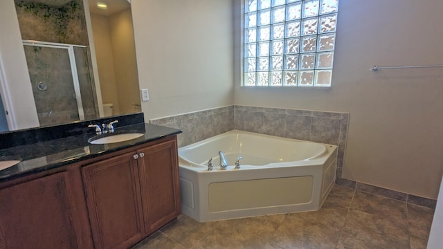 bathroom with vanity and independent shower and bath