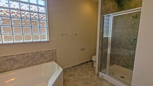 bathroom with toilet, plus walk in shower, and tile patterned floors