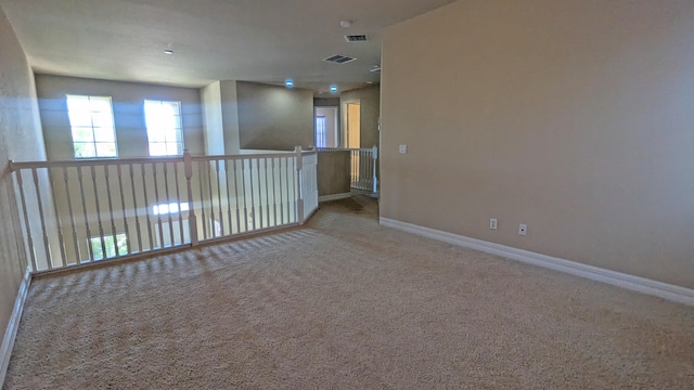 unfurnished room featuring light colored carpet