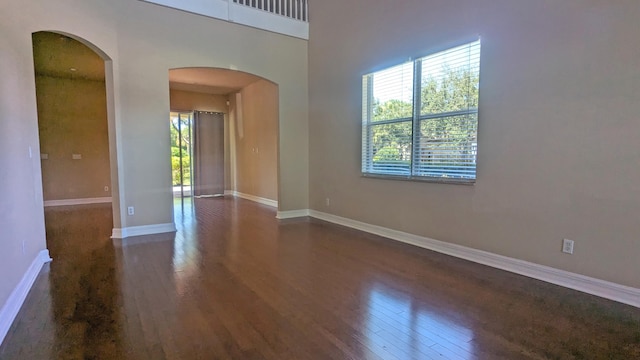 unfurnished room with dark hardwood / wood-style floors