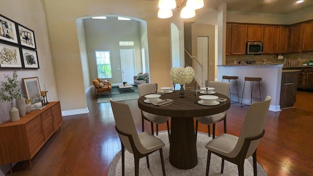 dining area featuring a chandelier and dark wood-type flooring