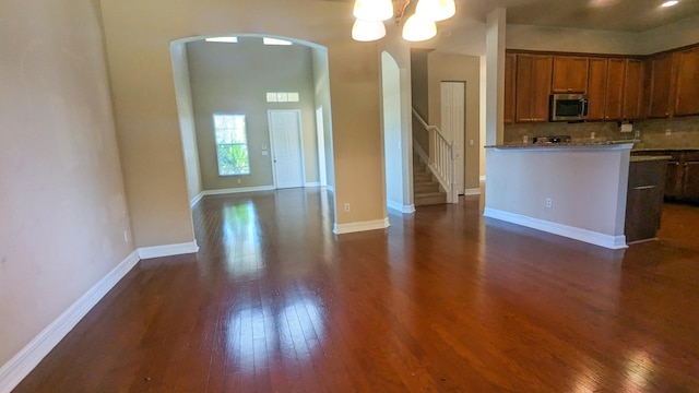 kitchen featuring a notable chandelier, dark hardwood / wood-style floors, and tasteful backsplash