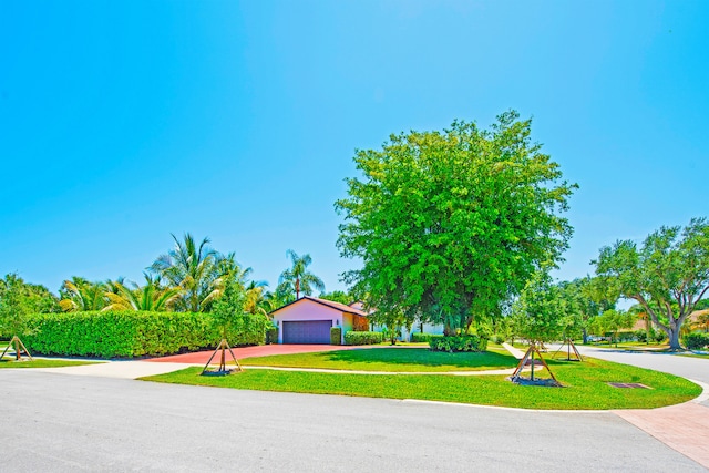 view of front of property with a garage and a front yard