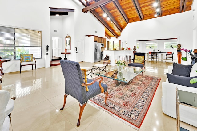 living room with beamed ceiling, a healthy amount of sunlight, wooden ceiling, and high vaulted ceiling