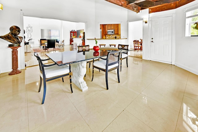 tiled dining area with beamed ceiling