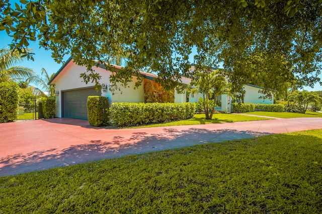 ranch-style home with a garage and a front yard