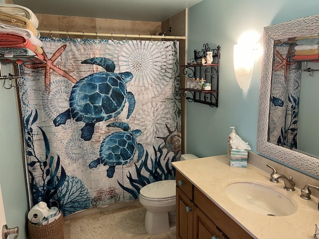 bathroom featuring tile patterned floors, vanity, and toilet