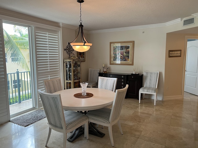 dining space featuring ornamental molding, a textured ceiling, and light tile patterned floors