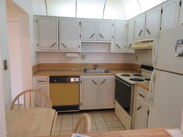 kitchen with light tile patterned floors, sink, and white appliances