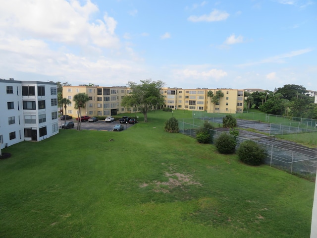 view of property's community featuring a yard