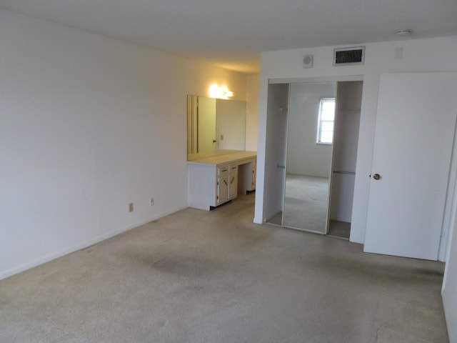 unfurnished bedroom featuring a closet and connected bathroom