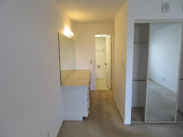 hallway with light colored carpet