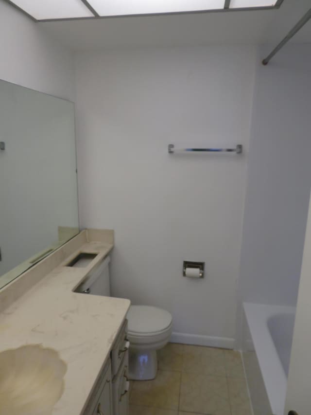 bathroom with toilet, tile patterned floors, and vanity