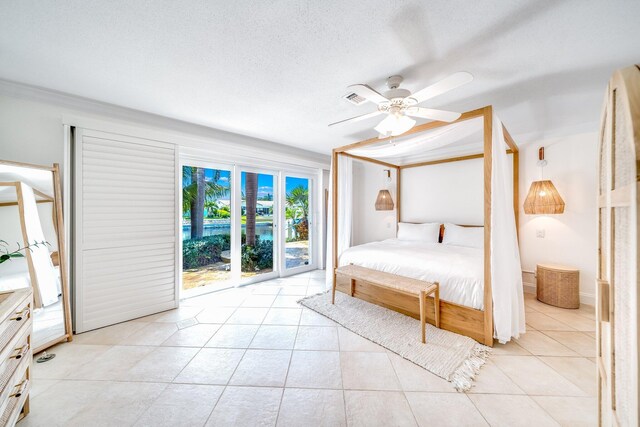 unfurnished bedroom featuring ceiling fan, access to outside, a textured ceiling, and light tile patterned floors