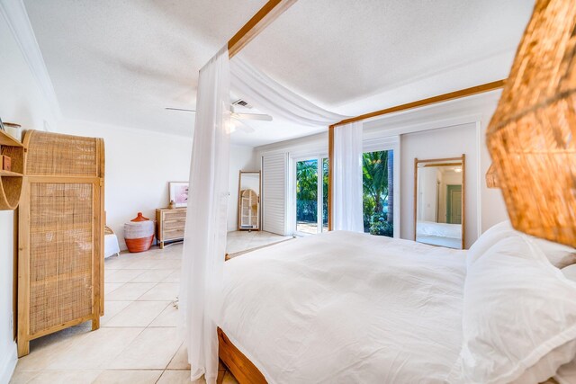 tiled bedroom featuring ceiling fan, crown molding, access to outside, and a textured ceiling