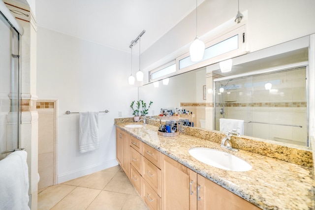 bathroom featuring dual vanity, tile patterned floors, and a shower with shower door