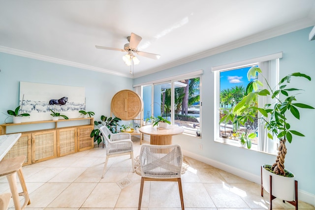 tiled dining space with ornamental molding and ceiling fan