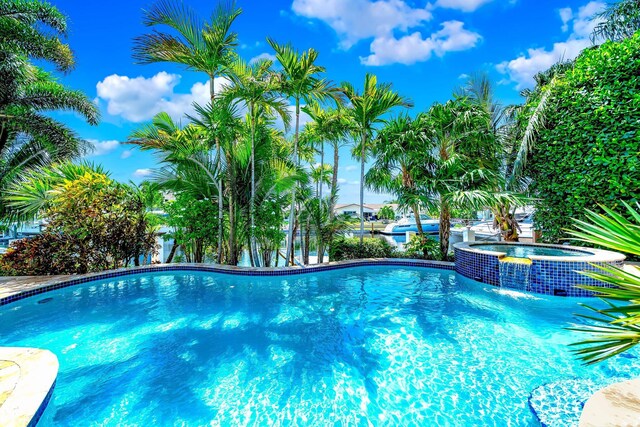 view of pool featuring an in ground hot tub